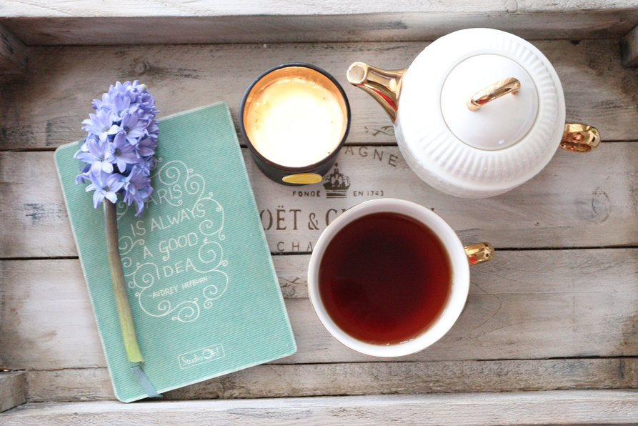 Teapot, a Mug of Tea, a Cup of Coffee and a Flower on a Wooden Tray